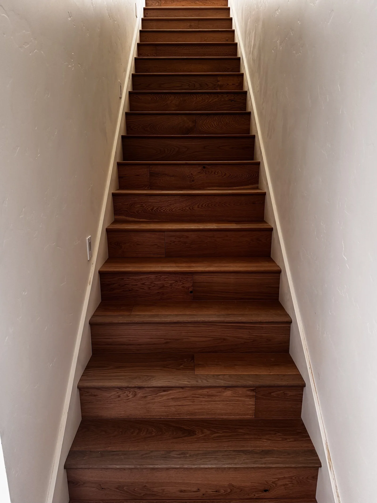 Wood stair treads in a finished stairwell