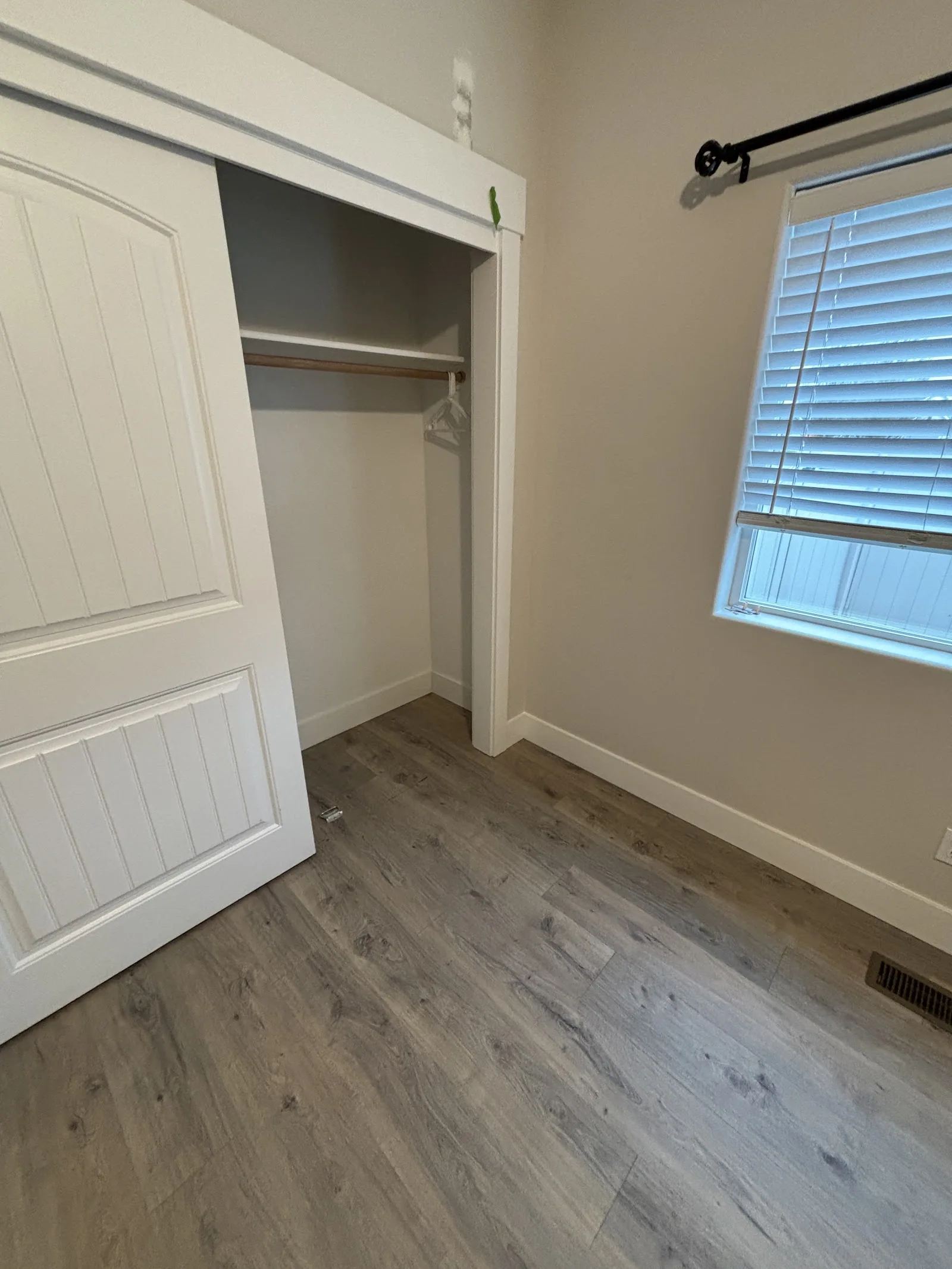 Gray plank laminate flooring in a bedroom