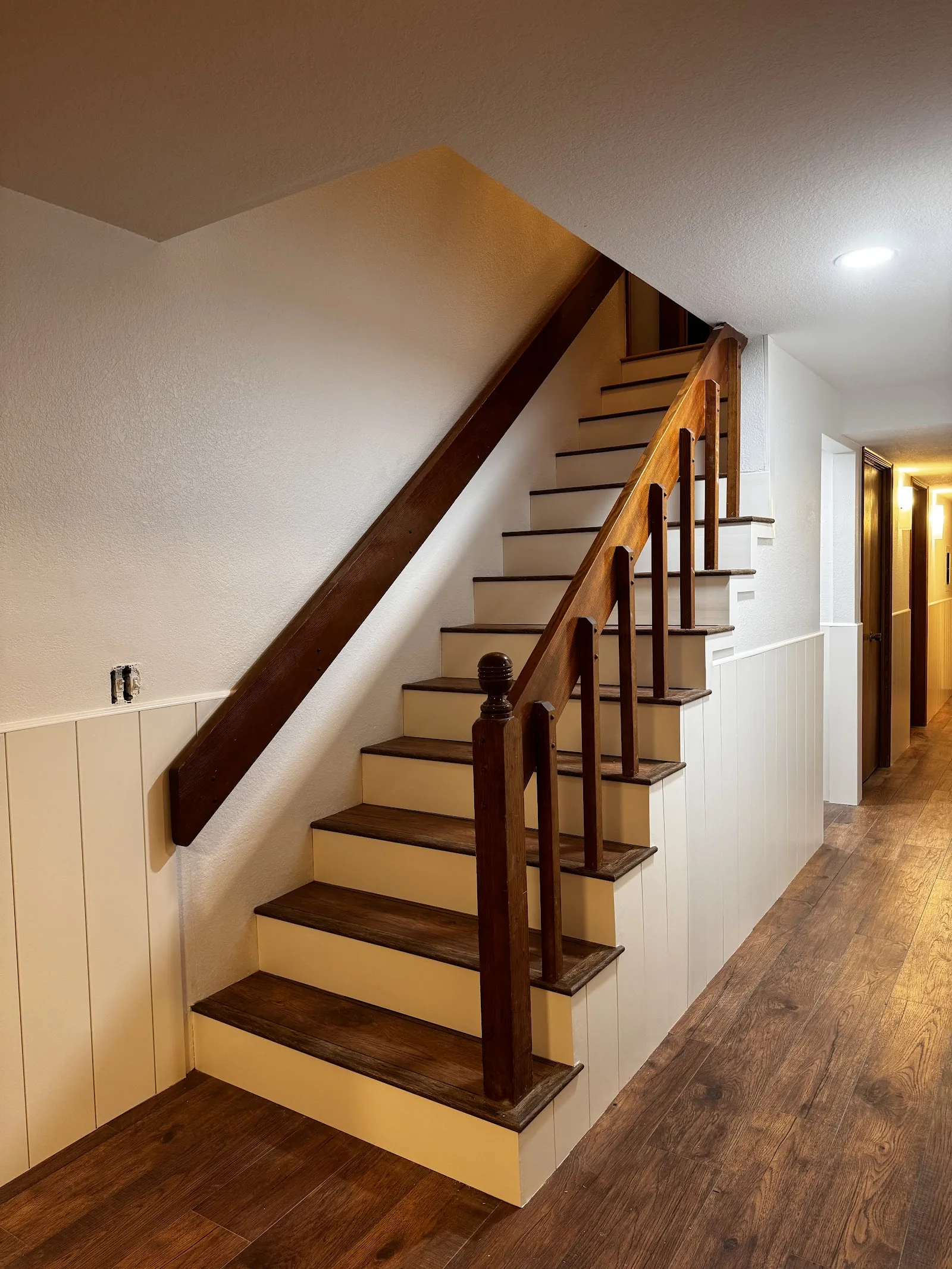 Finished laminate stairs and hallway by Urban Edge Construction