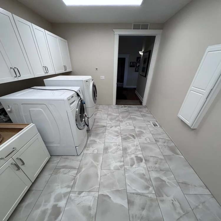 Marble-look luxury vinyl plank flooring installed in a laundry room