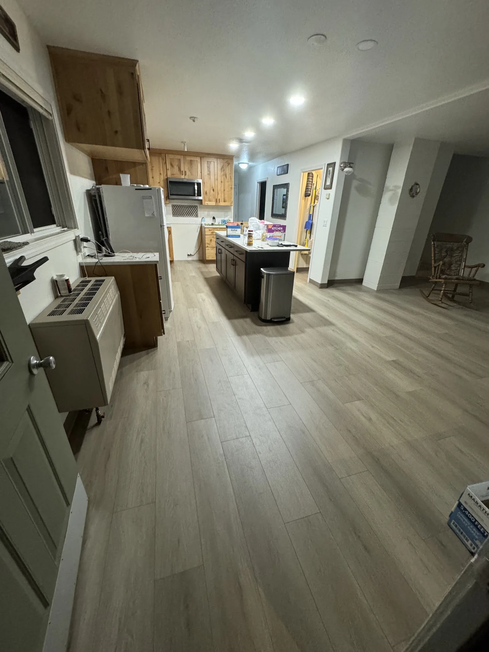 Luxury vinyl plank connecting a kitchen and hallway