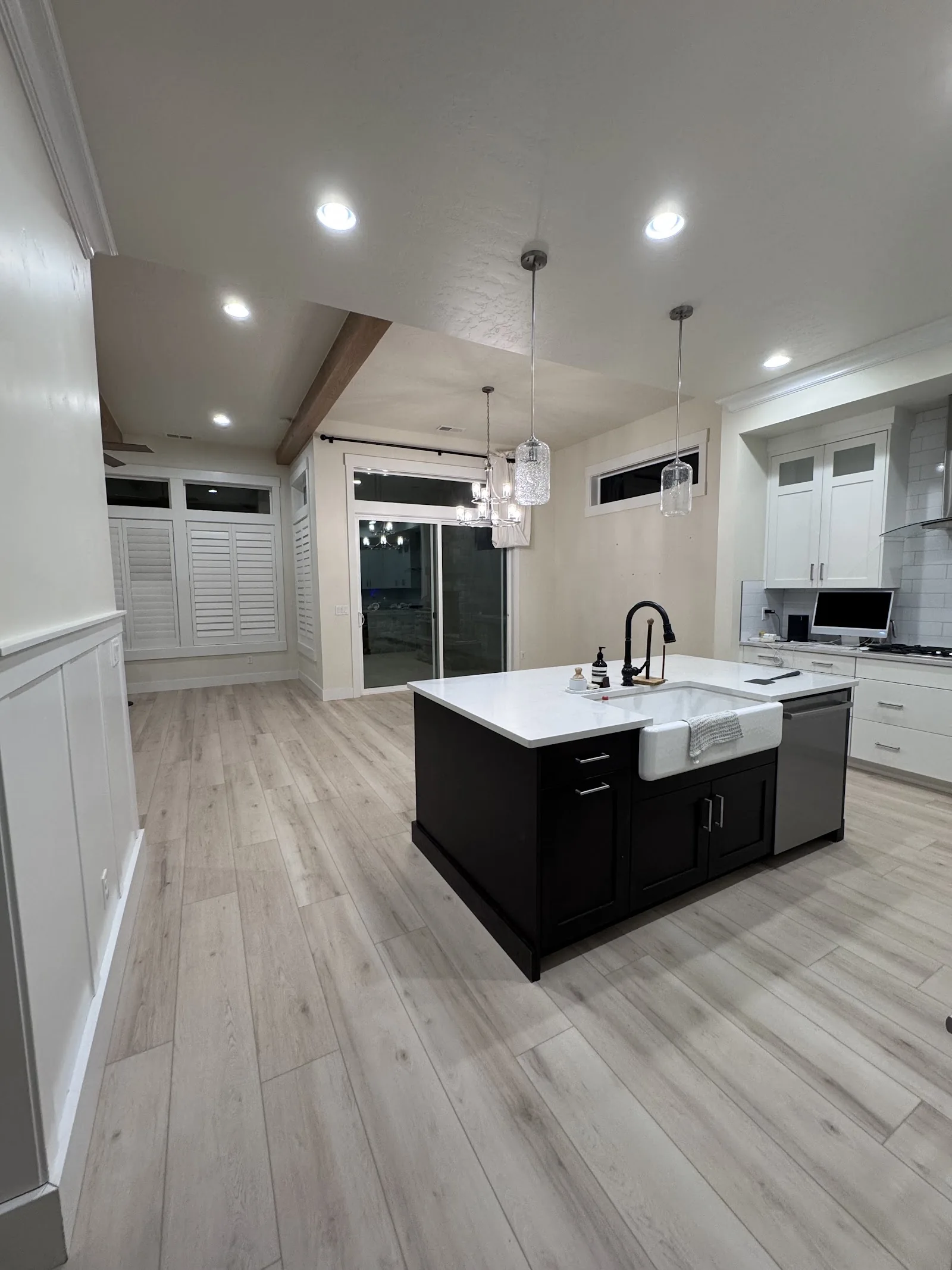 Light wood-look luxury vinyl plank in a white kitchen