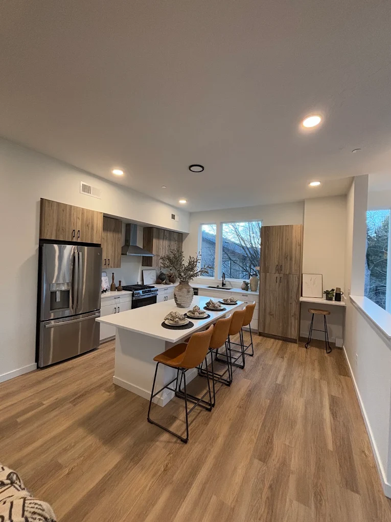 Warm oak-look luxury vinyl plank flooring in a finished Treasure Valley kitchen