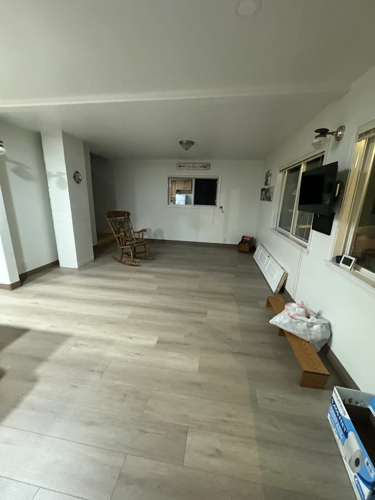 Light luxury vinyl plank flooring installed throughout a bright sunroom
